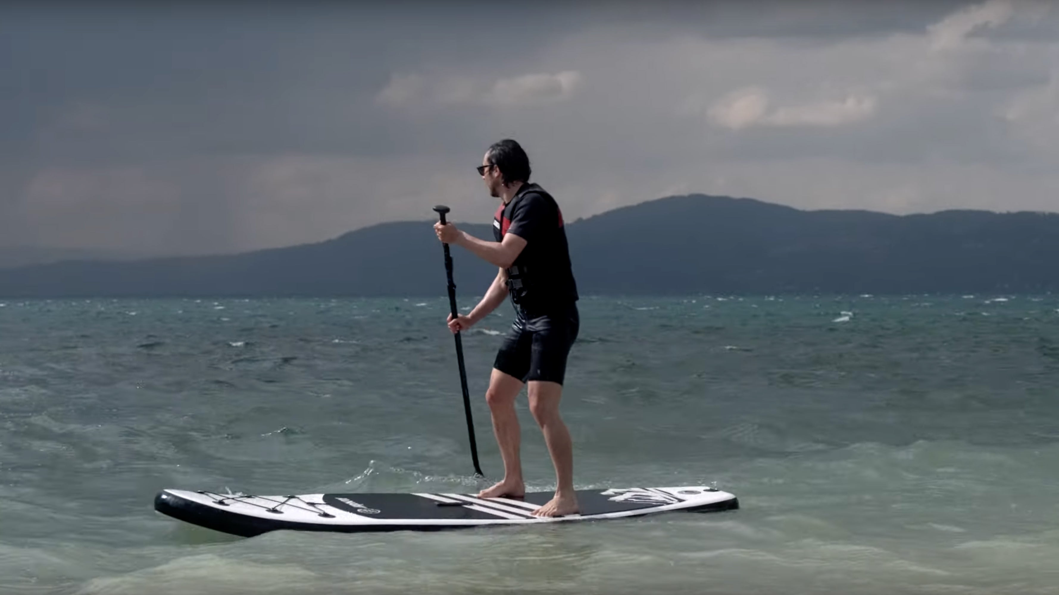 Man standing on SUP board in sea