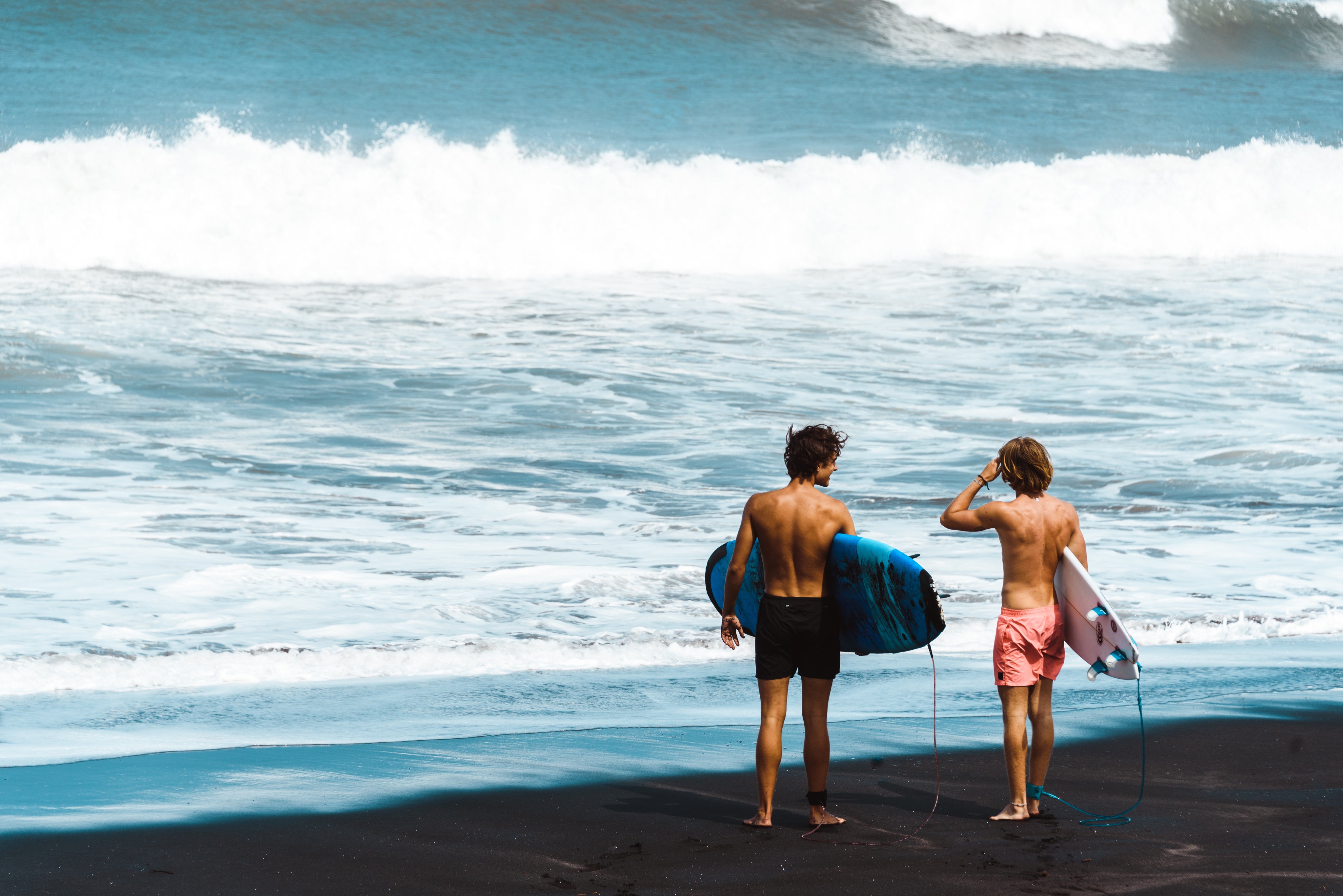 Surfers standing on the beach